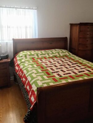 Blooming Rails Quilt on a bed