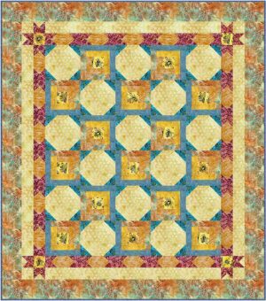 A colorful patchwork quilt with a floral border, blue and orange geometric patterns, and a grid of yellow squares featuring bee illustrations. The quilt has a symmetrical, intricate design.