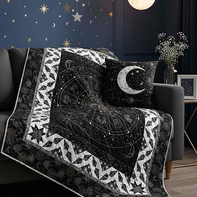 A dark, celestial-themed blanket with star and zodiac designs is draped over a gray sofa. A matching pillow with a crescent moon rests next to it. The background has navy walls decorated with gold stars and a moon-shaped light.