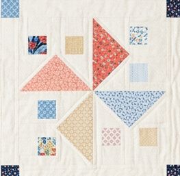 A quilt block with a cream background features colorful patterned squares and triangles in red, blue, yellow, and floral prints, arranged in a geometric, patchwork design inspired by the Aries Throw Quilt Pattern.