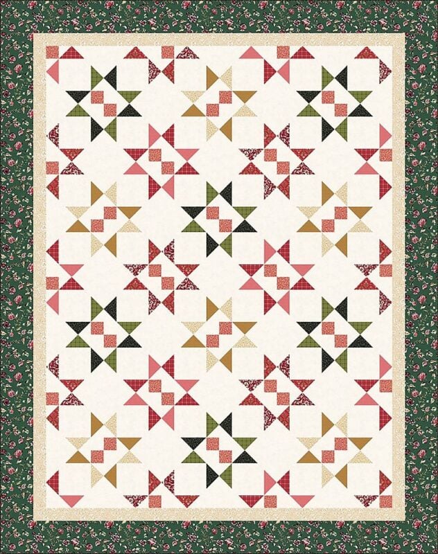 Cider and Cloves throw quilt with garnet, green, and caramel star blocks on a cream background, framed by a dark green floral border